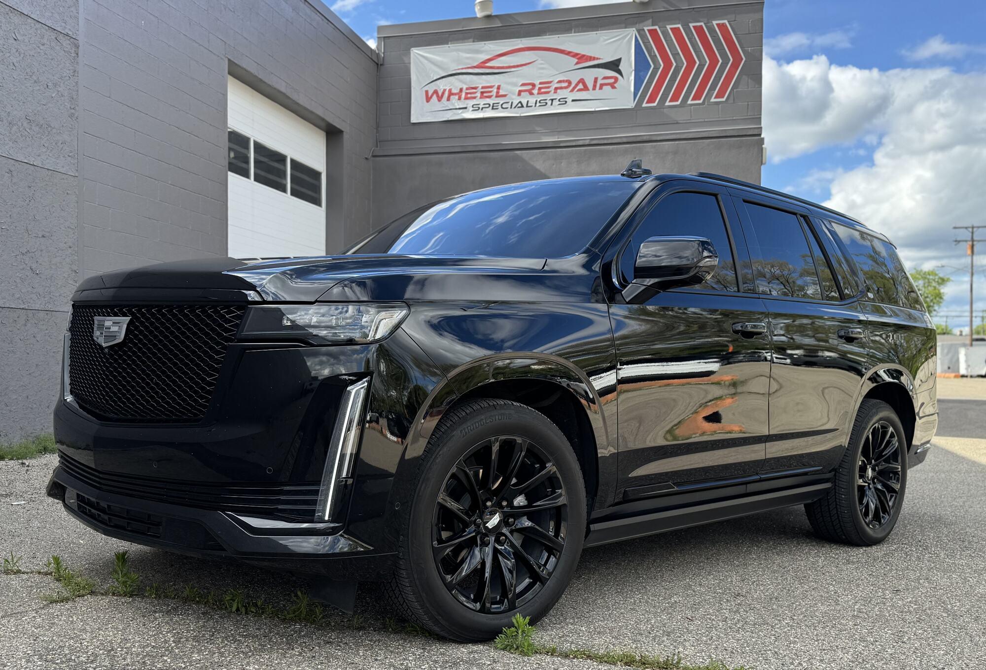 Black Cadillac Escalade with gloss black wheels