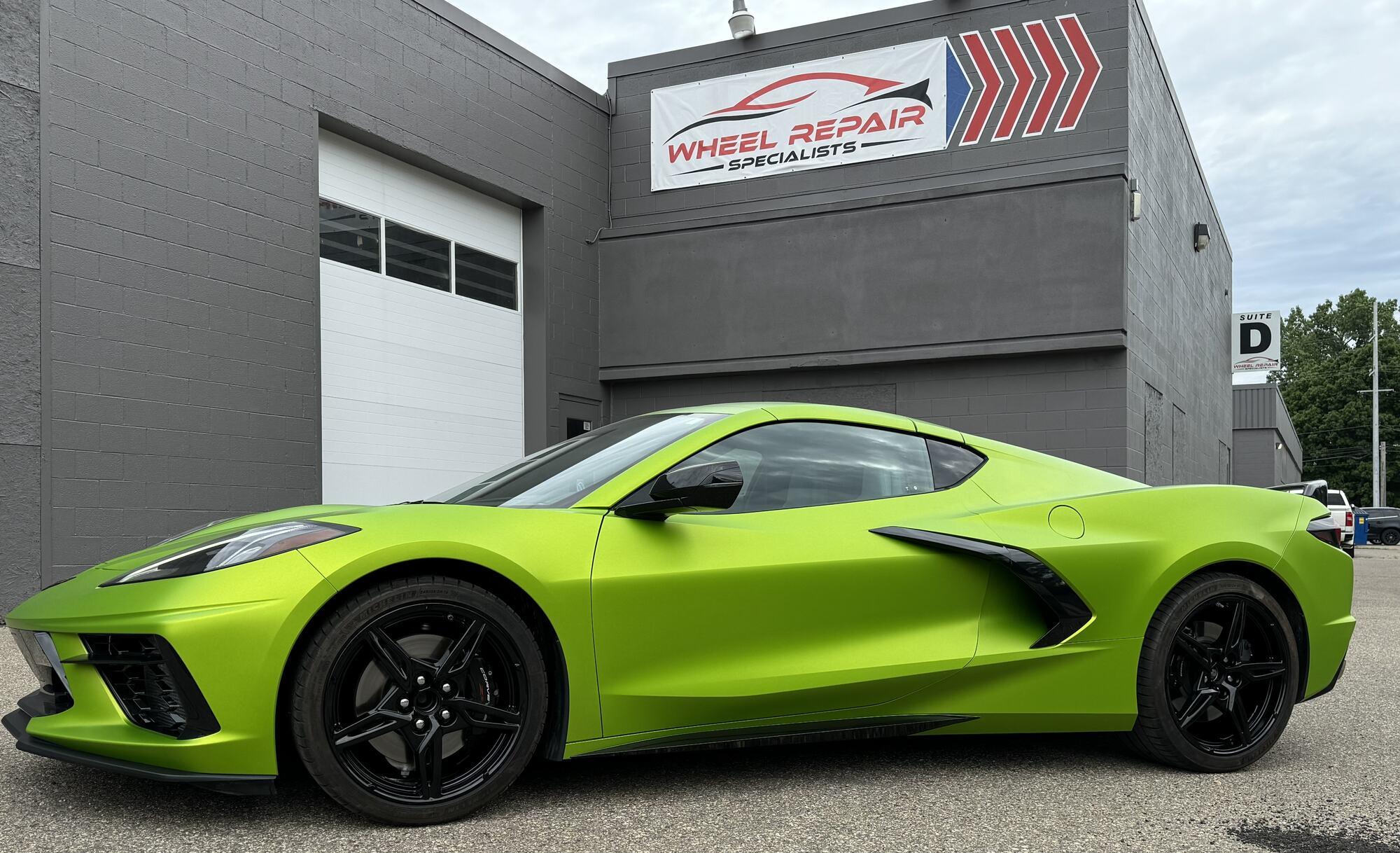Green Chevrolet Corvette with gloss black wheels outside Wheel Repair Specialists