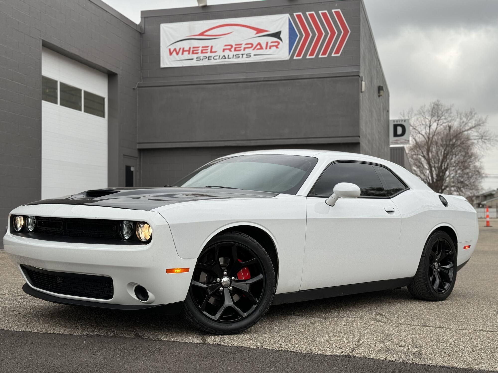 White Dodge Challenger with gloss black wheels