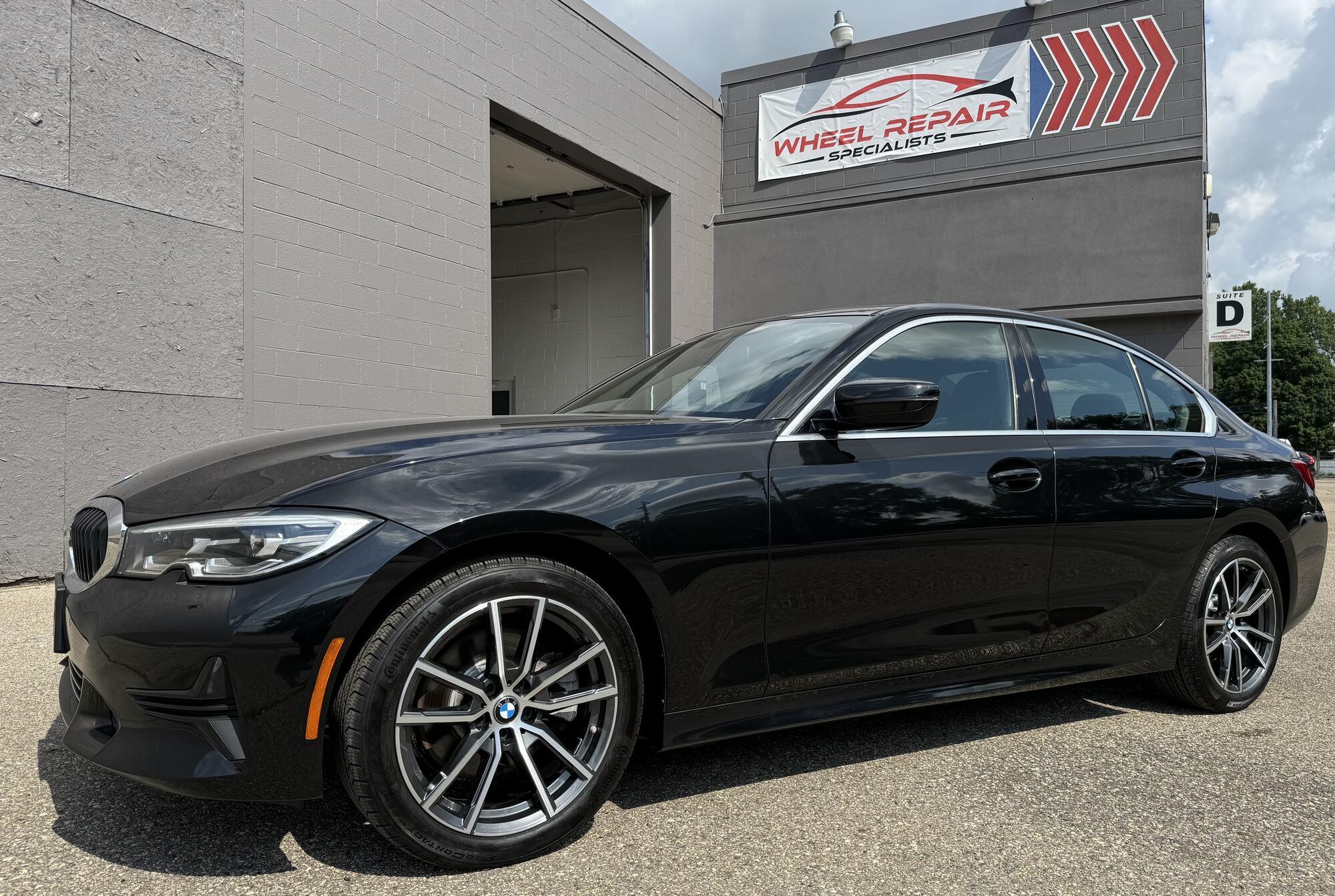 Black BMW 3 Series with silver refinished wheels