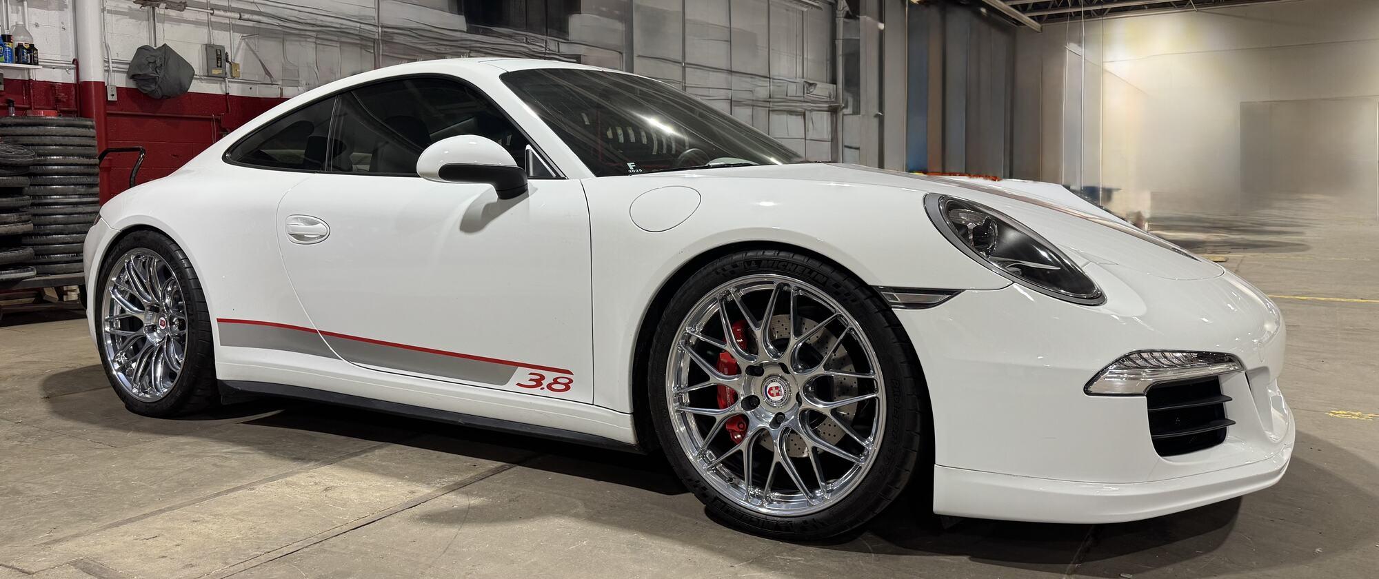 White Porsche 911 with chrome wheels